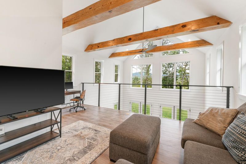 The upstairs loft, a second living area with a sectional and TV