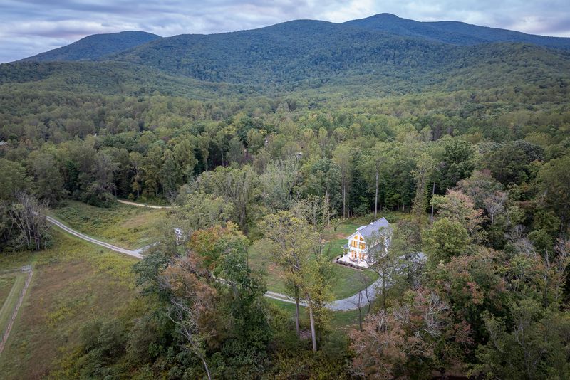 Hilltop House among the trees, with the Blue Ridge Mountains behind