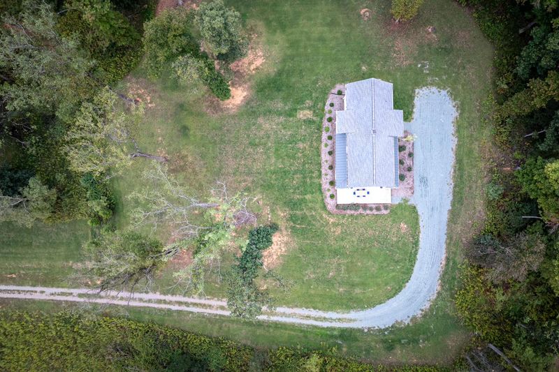 Looking straight down on the house, its drive and the surrounding woods